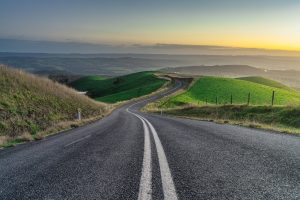Sunset view of Mount Alma Road winding through green hills and valleys near Adelaide, South Australia