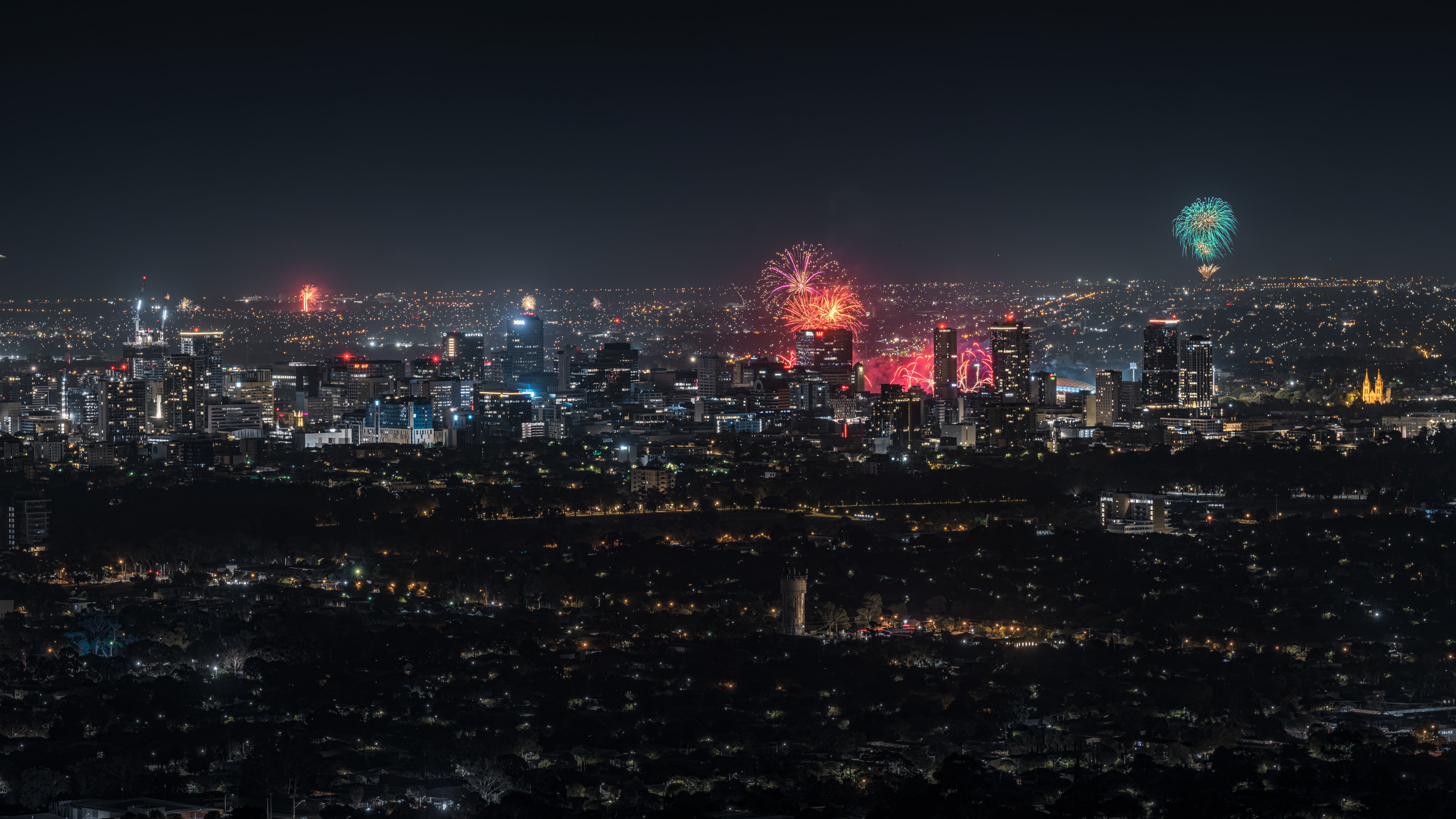 New Year’s Eve fireworks lighting up the Adelaide city skyline as seen from Mount Osmond Lookout, South Australia