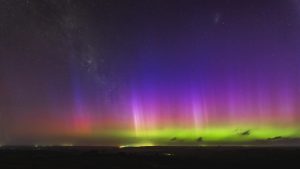 Bright multicolour aurora australis with red, green, and purple bands stretching across the night sky over Mannum, South Australia.