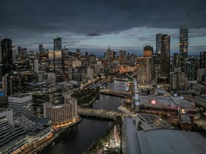 Melbourne City Skyline at Blue Hour – Aerial View of Yarra River Australia Melbourne city skyline at blue hour with Yarra River and illuminated buildings seen from aerial view in Victoria Australia