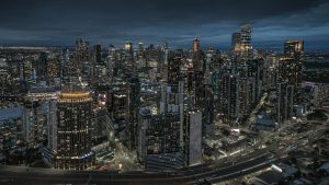Melbourne CBD Aerial View at Night – Urban Skyline and City Lights Australia Melbourne CBD aerial view at night with skyscrapers roads and city lights in Victoria Australia