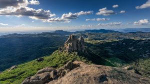 The Cathedral Mount Buffalo – Dramatic Granite Peaks in Victoria Australia The Cathedral granite rock formation at Mount Buffalo National Park in Victoria Australia surrounded by green alpine landscape under dramatic clouds