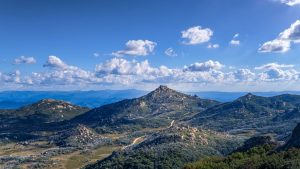 The Hump Lookout Mount Buffalo – Panoramic Alpine Landscape Victoria Australia Panoramic view from The Hump Lookout at Mount Buffalo National Park showing alpine mountains granite peaks and a winding road in Victoria Australia