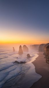 Twelve Apostles at Twilight – Great Ocean Road Coastal Photography Australia Twelve Apostles at twilight on the Great Ocean Road in Victoria Australia with soft pastel sky and ocean waves around limestone sea stacks