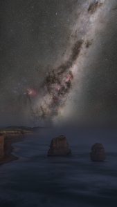 Milky Way above the Twelve Apostles in Victoria Australia with ocean coastline and limestone sea stacks under a dark night sky