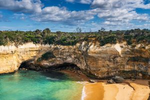Golden sandy beach and limestone cave at Loch Ard Gorge in Victoria, Australia