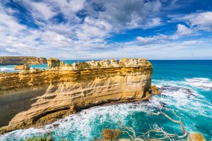 Layered limestone cliffs and turquoise ocean near Loch Ard Gorge on the Great Ocean Road