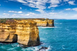 Golden limestone cliffs and turquoise ocean at Loch Ard Gorge on the Great Ocean Road