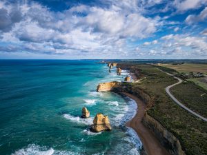 Drone view of the Twelve Apostles coastline with turquoise ocean and the Great Ocean Road in Victoria, Australia