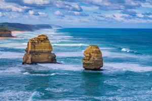 The Twelve Apostles with turquoise ocean water under dramatic clouds in Victoria, Australia