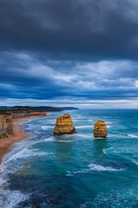 Limestone sea stacks beneath dramatic storm clouds along the Great Ocean Road