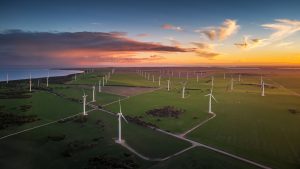 Yorke Peninsula Wind Farm at Sunset, South Australia Aerial view of a wind farm at sunset on the Yorke Peninsula, featuring rows of wind turbines across green farmland beneath a colourful evening sky.
